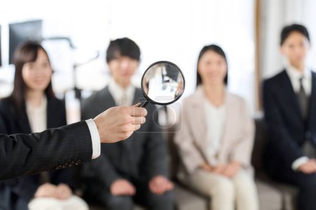 Image of searching for human resources with a magnifying glass