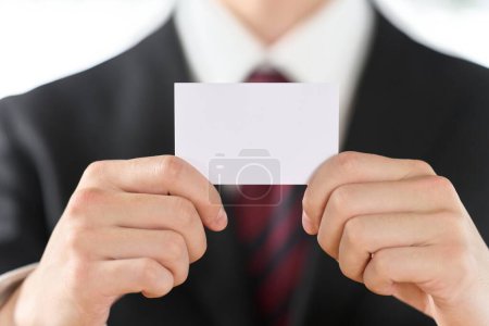 Hand of a businessman holding a business card