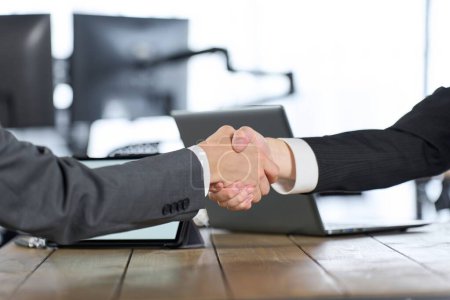 Businessman signing a contract and shaking hands