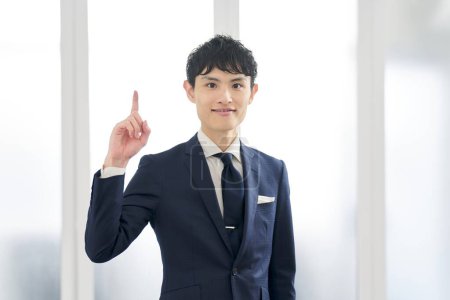 A businessman wearing a custom suit and pointing