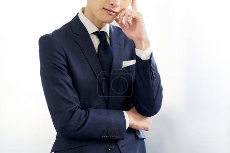 Photo for A businessman who is worried about wearing a custom suit - Royalty Free Image