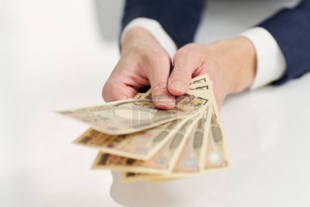 Hand of businessman paying money
