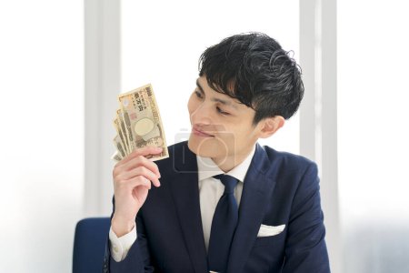 Businessman smiling and holding money