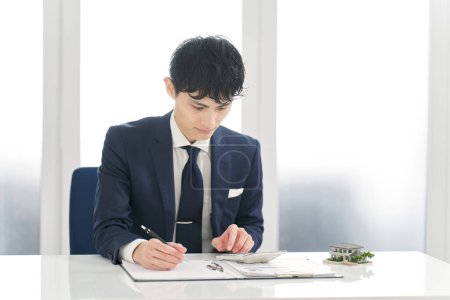 Businessman calculating money related to real estate