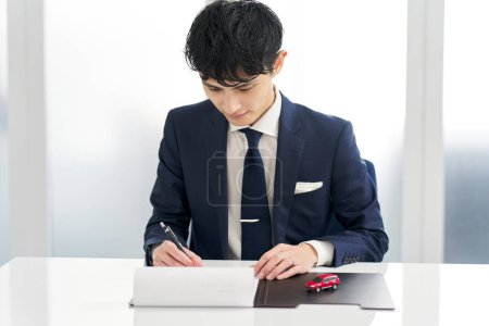 Businessman signing a car contract