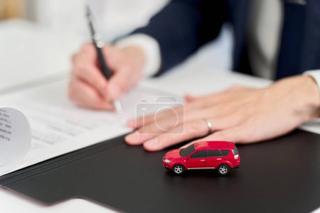 Businessman signing a car contract
