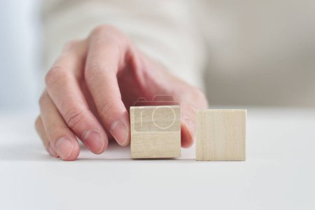 Hand holding a solid wooden block