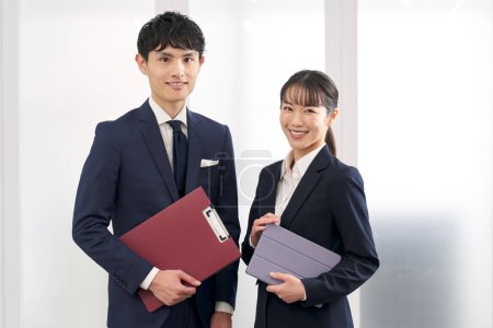Male and female business people standing in the office
