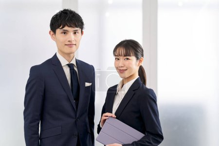 Male and female business people standing in the office