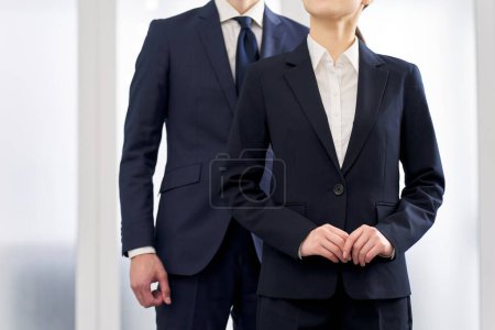 Male and female business people wearing suits