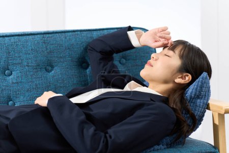 A woman lying on the sofa tired from work