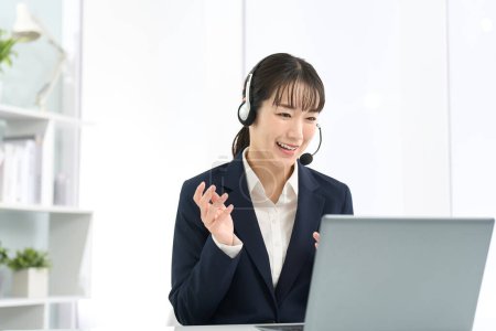 Business woman wearing a headset and having a conversation