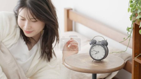 woman getting out of bed in the morning
