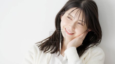 Photo for Woman listening to music in bed - Royalty Free Image