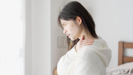 A woman caring about her aching shoulder