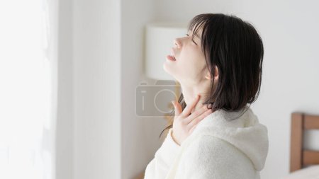 A woman caring about her sore throat