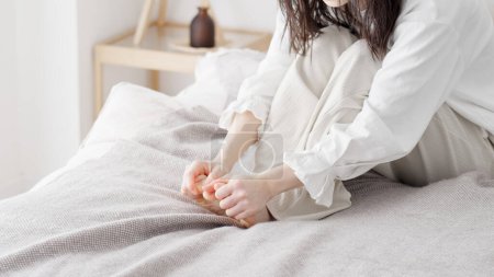 A woman rubbing her cold feet