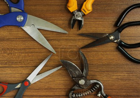 Several Types of Cutting Scissors Tools on wooden background
