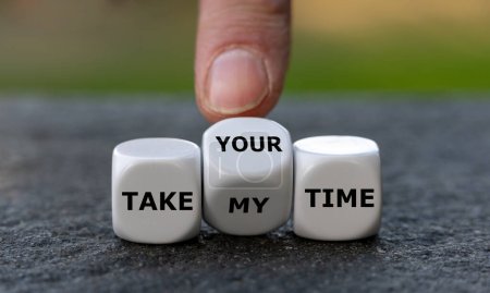 Hand turns dice and changes the expression 'take my time' to 'take your time'.