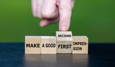 Téléchargez les photos : Symbol for a second chance. Hand turns wooden cube and changes the expression 'make a good first impression' to 'make a good second impression'. - en image libre de droit