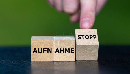 Photo for Wooden cubes form the German expression 'Aufnahme stopp' (migration stop). - Royalty Free Image