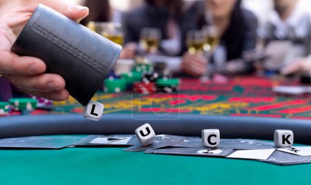 Dice form the word luck on a gambling table in a casino. 