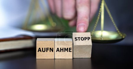 Photo for Wooden cubes form the German expression 'Aufnahme stopp' (migration stop). - Royalty Free Image