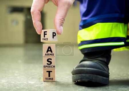 Photo for A stack of wooden cubes forms the expression FAST. FAST stands for "facial drooping", "arm weakness", "speech difficulties" and "time to call emergency services". - Royalty Free Image