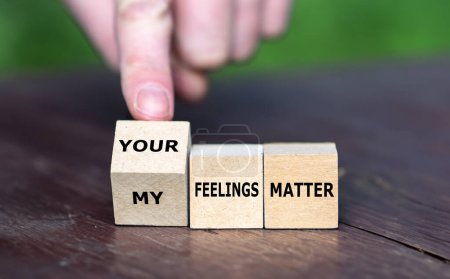 Hand turns wooden cubes and change the expression 'my feelings matter' to 'your feelings matter'.