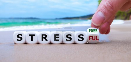Photo for Hand turns dice and changes the expression 'stressful' to 'stress free'. - Royalty Free Image