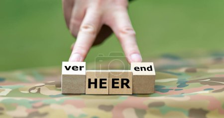 Hand turns cube and changes the German word 'Heer' (army) to 'verheerend' (disastrous). Symbol for the disastrous situation of the German army.