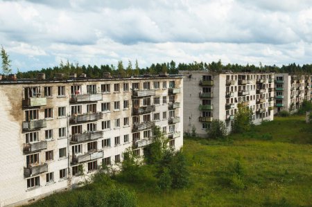 Photo for Exterior of an abandoned apartment buildings with broken windows in a desolate european ghost town. - Royalty Free Image