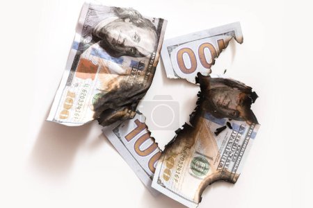 Photo for Closeup shot of a torn and burnt one hundred dollar bills. Concept of economic crisis, inflation and business failure. - Royalty Free Image