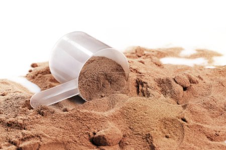 Photo for Closeup of scoop with chocolate whey protein or mass gainer powder - Royalty Free Image
