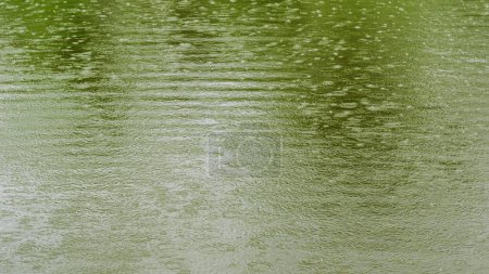 Photo for Background image of water ripples on a pond surface during heavy rain. - Royalty Free Image
