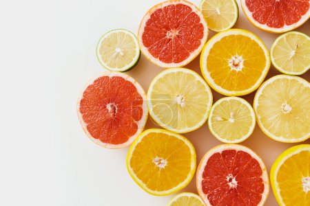 Photo for Different sliced citrus fruits such as grapefruit, orange, lemon and lime on white background - Royalty Free Image