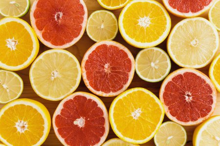 Photo for Closeup image of different sliced citrus fruits such as grapefruit, orange, lemon and lime - Royalty Free Image