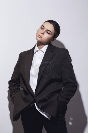 Photo for Fashionable studio portrait of young masculine woman against white background - Royalty Free Image