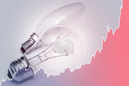 Photo for Light bulbs and rising sparkline chart representing current high electricity price during energy crisis in the world - Royalty Free Image