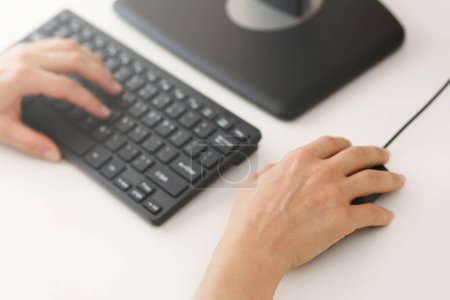 Photo for Closeup of female hands using computer pc on workplace in office - Royalty Free Image