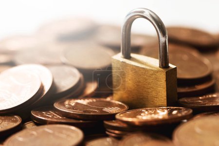 Photo for Small brass lock on a pile of shiny copper euro coins. - Royalty Free Image
