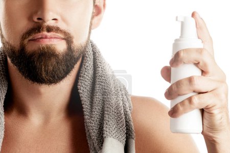 Man with a cleansing or shaving foam on white background