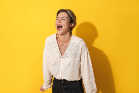 Photo for Portrait of young cheerful woman on yellow background - Royalty Free Image