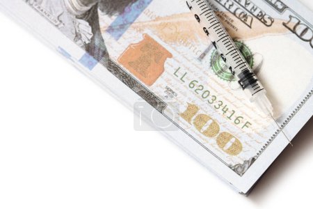 Photo for Closeup shot of an empty plastic syringe lying on a stack of money. Concept of expenses of covid-19 consequences and vaccination. - Royalty Free Image
