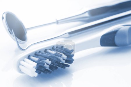 Photo for Closeup of toothbrush and dental equipment in blue light - Royalty Free Image
