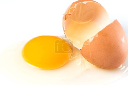 Photo for Close Up of broken chicken egg with a yolk and egg white pouring out - Royalty Free Image