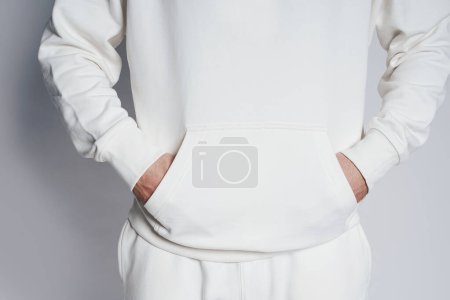 Photo for Man wearing blank white hoodie against light gray background - Royalty Free Image