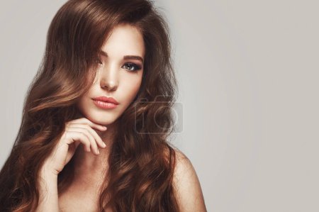 Photo for Portrait of beautiful young woman with long wavy hair - Royalty Free Image