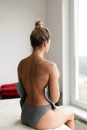 Photo for Young woman relaxing after professional massage session - Royalty Free Image