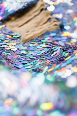 Photo for Closeup shot of a shiny multicolored sequin fabric made of linked colorful metallic circles. - Royalty Free Image